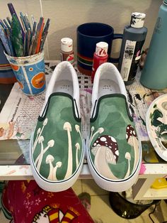 Hand-Painted slip-on canvas shoes featuring brown and red mushrooms and fungi! 🍄 Every pair is hand-painted by me, and all designs come in men's, women's, and kids. If you are unsure about a size or are a half-size, I recommend going ONE SIZE UP. Please keep in mind that every pair I sell is HAND-PAINTED, therefore there may be minor imperfections, however that does NOT defer the value or worth of the pair. 💚 (Note: The default shoe that I use is NOT a name-brand shoe, but a Vans-style canvas Bottom Of Shoe Painting, Painted Vans Slip On Diy, Painted Shoe Designs, Painting Vans Shoes, Diy Shoe Designs Paint, Cool Painted Shoes, Shoe Design Ideas Diy, Vans Design Shoes Diy, Vans Art Shoes