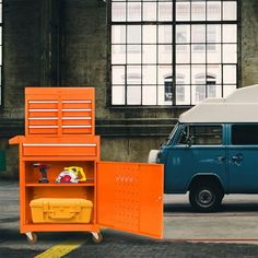 an orange and white van is parked next to a shelf