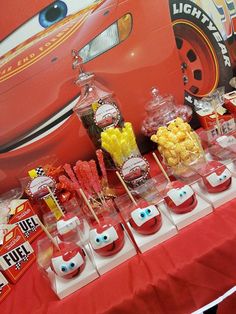 the cars birthday party table is full of candy and candies, including marshmallows