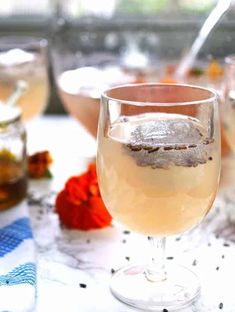 three glasses filled with different types of drinks on a table next to some strawberries