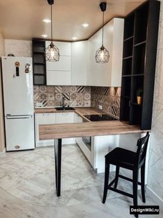 a kitchen with white cabinets and wooden counter tops, black chairs, and an island in the middle