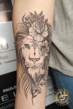 a woman's arm with a lion and flowers on it