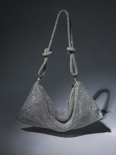 Introducing the Jean Rhinestone Shoulder Bag In Silver. Made from eye-catching sliver rhinestones that give a metallic silver shine, it's designed with a knotted shoulder strap and a slouchy silhouette that will store all your daily essentials. Material: PU 14.2inch / 36cm diameter (dimensions approx.) Silver Rhinestone Shoulder Bag For Night Out, Glamorous Silver Shoulder Bag With Bling, Silver Bling Bags For Night Out, Elegant Metallic Silver Shoulder Bag For Party, Glamorous Silver Shoulder Bag With Rhinestones, Silver Shoulder Bag With Rhinestones For Party, Silver Rhinestone Shoulder Bag For Parties, Silver Evening Bag With Bling For Night Out, Sparkling Silver Evening Bag For Night Out