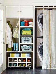 a washer and dryer in a room with open shelves next to each other