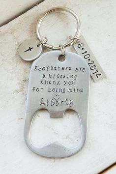 a bottle opener keychain with a message on it that says, godfathers are a blessing thank you for being mine liberty