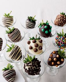 chocolate covered strawberries are arranged in glass bowls