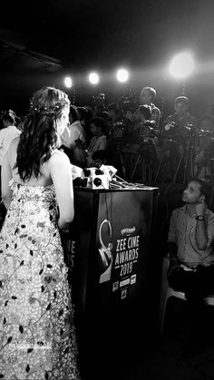 black and white photograph of a woman at a podium in front of a large crowd