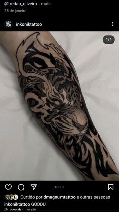 a black and white tiger tattoo on the arm