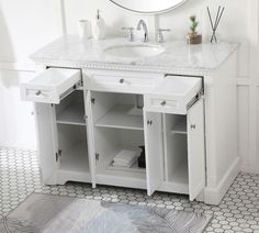 a white bathroom vanity with marble top and drawers