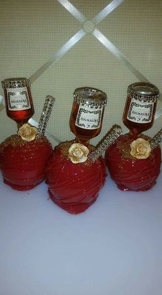 four red apples with honey jars on them