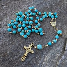 This precious handmade catholic rosary is made with gold tone tarnish resistant wire with natural 6-8mm turquoise beads ,gold plated crucifix and centerpiece. The turquoise beads are 100% natural. This piece is handmade. Each item is send in a small organza bag. Bohemian Gold Rosary With 8mm Beads, Gold Bohemian Rosary With 8mm Beads, Star Centerpieces, Catholic Rosary, Rosary Catholic, Bleu Turquoise, Pink Quartz, Jewelry Companies, Amethyst Stone