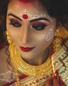 a woman with makeup and jewelry on her face