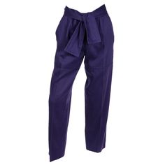 These vintage Yves Saint Laurent purple cotton trousers are anything but ordinary! The color is the perfect rich, jewel tone saturated purple and we fell in love the with attached sash belt that can be tied in numerous ways. These pants have a flattering fit and side slit pockets. The interesting seams almost pay homage to cargo pants. There is a front zipper closure with a hook and eye and button at the waist. Saint Laurent Rive Gauche, Made in France. Excellent condition. Marked as a French si Ysl Vintage, Vintage Yves Saint Laurent, Sash Belts, Cotton Trousers, Rive Gauche, Sash Belt, We Fall In Love, Fell In Love, Deep Purple