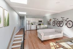 a living room filled with furniture and bicycles mounted to the wall