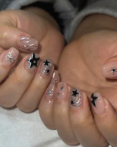 These nails feature a nude base with black and white star and swirl designs, capturing the essence of summer nights under the stars. 🌸Click on the image to shop our trending Korean Gel Polish this season. 🌸Credit: jiniquenail on Instagram🌸summer nails, star nails, swirl nails, nude  nails, black and white nails, Korean gel polish, trendy nails, summer night nails, celestial nail art, nail art inspiration, manicure ideas, summer manicure, nail aesthetics, nude nails, starry night nails, gel polish nails, summer beauty trends, instagram nail art, trendy summer nails, nail design trends Metallic Star Nails, Nails Starry Night, Manicure Ideas Summer, Nails Celestial, Starry Night Nails, Celestial Nail Art, Korean Gel Polish, Nails Swirl, Night Nails