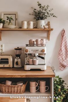 a coffee maker sitting on top of a wooden counter next to a shelf filled with cups and mugs