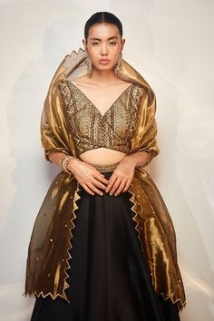 Black, gold attached cancan lehenga with cutdana, sequin embroidered border. Paired with sleeveless embroidered padded blouse and cutwork bordered dupatta. - Aza Fashions Criss Cross Blouse, Cape Lehenga, Cancan Lehenga, Kurta Lehenga, Lehenga Pattern, Black Lehenga, Padded Blouse, Lehenga Skirt, Embroidered Lehenga