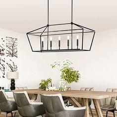 a dining room table with chairs and a chandelier hanging from it's ceiling