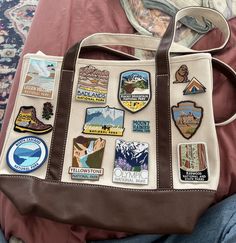 a brown and white bag with stickers on it sitting on a person's lap