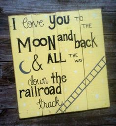 a wooden sign that says i love you to the moon and back and down the railroad track