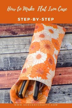 an orange and white flowered bag with scissors in it on top of a wooden table