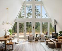 a living room filled with furniture and large windows