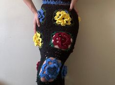 a woman is wearing a skirt made out of crochet and has her hands on the hips