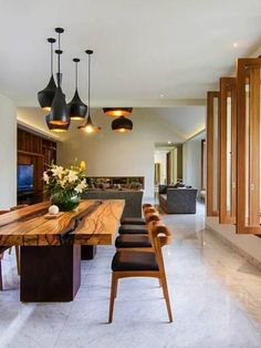 a long wooden table sitting in the middle of a living room