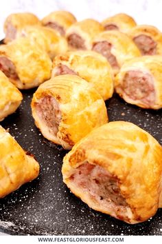 several pastries are arranged on a black plate