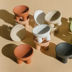 several different colored vases sitting on top of a brown table next to each other