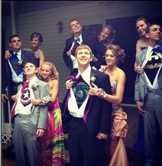 a group of young people standing next to each other in front of a house wearing suits and ties