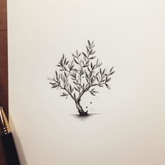 a drawing of a small tree with leaves on it's branches and watercolor pencils