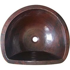 an oval shaped sink with a brown finish