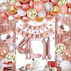 a birthday party with balloons, cake and decorations