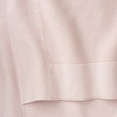 the back of a pink sweater with buttons