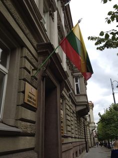 a flag hanging on the side of a building