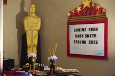 a baby's birthday party is set up in the corner of a room with an oscar statue