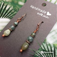 Elevate Your Earring Game With These Stunning Handcrafted Moss Agate Earrings. Each Pair Features Genuine Moss Agate Stones Delicately Wrapped In Copper Wire, Accented With Hand-Torched And Oxidized Ball Pins For A Charming Aged Look. The Natural Beauty Of Moss Agate Is Perfectly Complemented By The Warmth Of Copper, Creating A Captivating Blend Of Earthy Tones And Artisanal Craftsmanship. Whether You're Dressing Up For A Night Out Or Adding A Touch Of Bohemian Flair To Your Everyday Attire, The Gift Gemstone Beaded Earrings, Adjustable Jade Beaded Earrings As A Gift, Jade Beaded Earrings With Ear Wire As Gift, Jade Beaded Earrings With Ear Wire For Gifts, Jade Beaded Earrings As Gift, Wire Wrapped Agate Earrings As Gift, Wire Wrapped Agate Earrings For Gift, Jade Beaded Dangle Earrings For Gift, Jade Earrings With Dangling Beads As A Gift