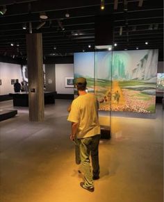 a man standing in front of a large painting