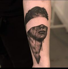 a man's arm with a black and white photo of his face on it