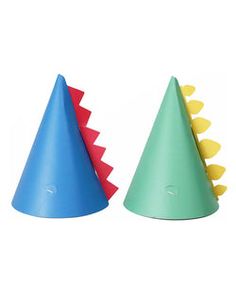 two small plastic hats with spikes on them, one blue and one green are sitting next to each other