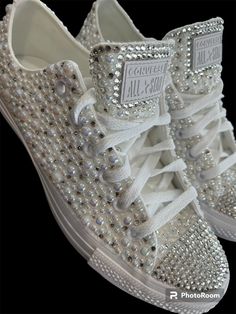 a pair of white sneakers with lots of diamonds on them