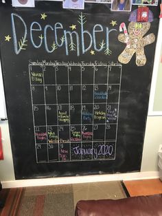 a chalk board with a calendar and teddy bear on it