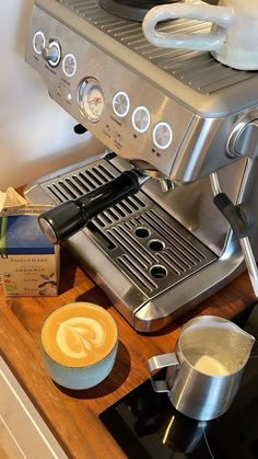 an espresso machine sitting on top of a wooden counter