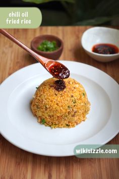 a white plate topped with rice covered in sauce