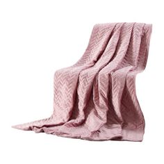 a pink blanket sitting on top of a chair