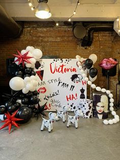 balloons and decorations are set up in front of a sign