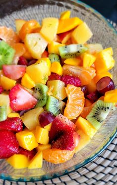 a glass bowl filled with sliced fruit on top of a table