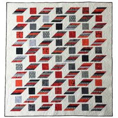 a red and black quilt with squares on it