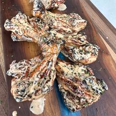 several pieces of meat on a wooden cutting board